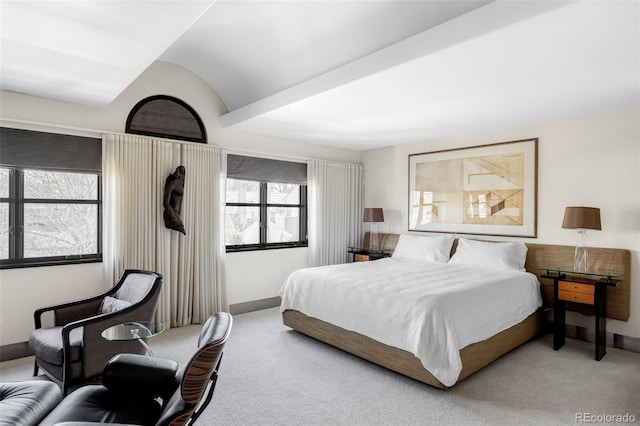 carpeted bedroom with baseboards and vaulted ceiling
