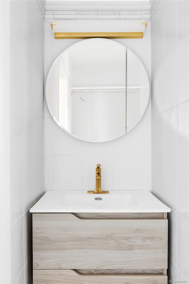 bathroom featuring vanity and tile walls