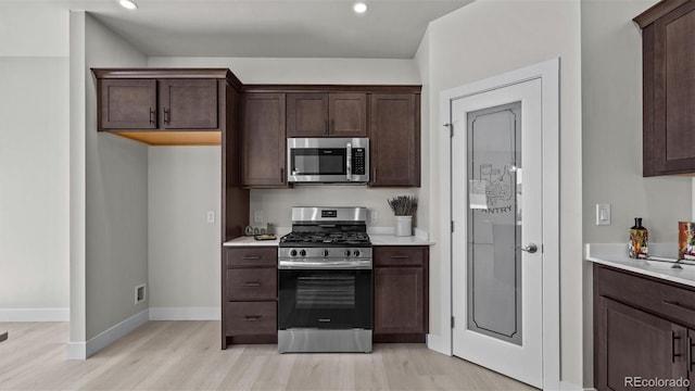 434 Clear Creek Dr, Grand Junction, CO 81504 - kitchen featuring stainless steel appliances, light wood-type flooring, light countertops, dark brown cabinets, and recessed lighting