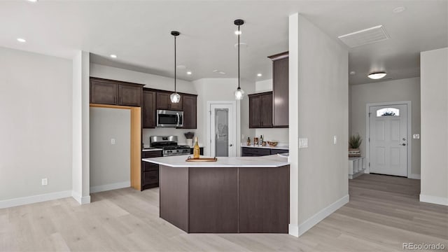 434 Clear Creek Dr, Grand Junction, CO 81504 - kitchen featuring stainless steel appliances, light wood-style floors, dark brown cabinetry, light countertops, and a peninsula