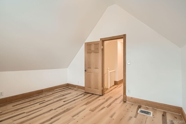 160 W Bayaud Ave, Denver, CO 80223 - additional living space with vaulted ceiling, baseboards, and light wood-type flooring