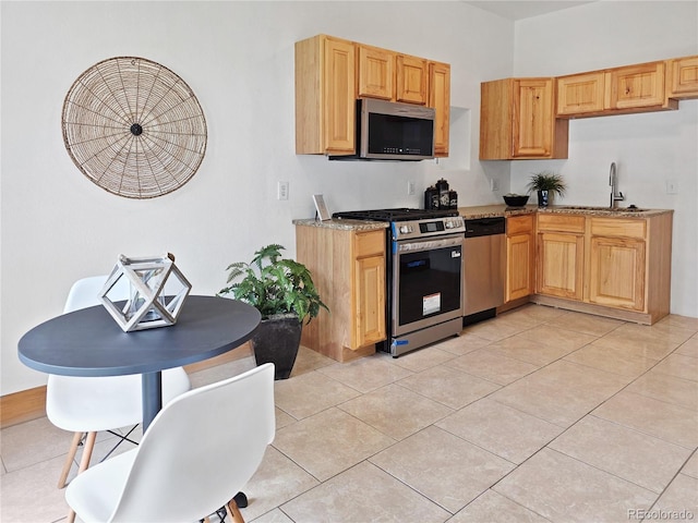 160 W Bayaud Ave, Denver, CO 80223 - kitchen featuring appliances with stainless steel finishes, a sink, light brown cabinets, and light tile patterned flooring