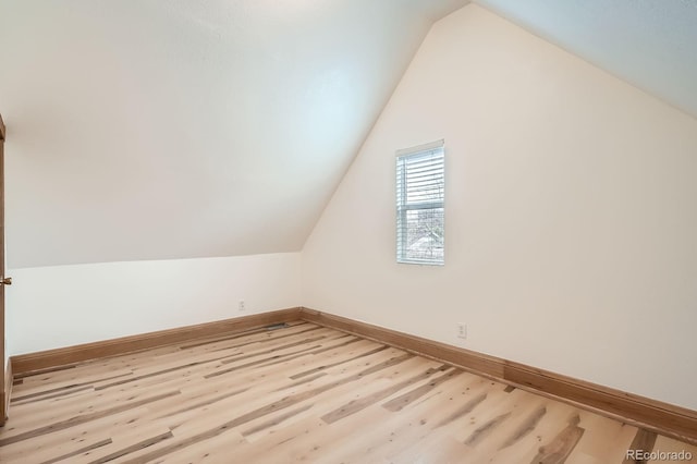 160 W Bayaud Ave, Denver, CO 80223 - additional living space featuring wood finished floors, baseboards, and lofted ceiling