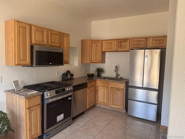 160 W Bayaud Ave, Denver, CO 80223 - kitchen with appliances with stainless steel finishes, dark stone countertops, and light tile patterned flooring