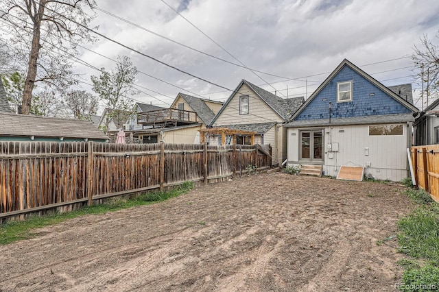 160 W Bayaud Ave, Denver, CO 80223 - back of house with a fenced backyard and entry steps