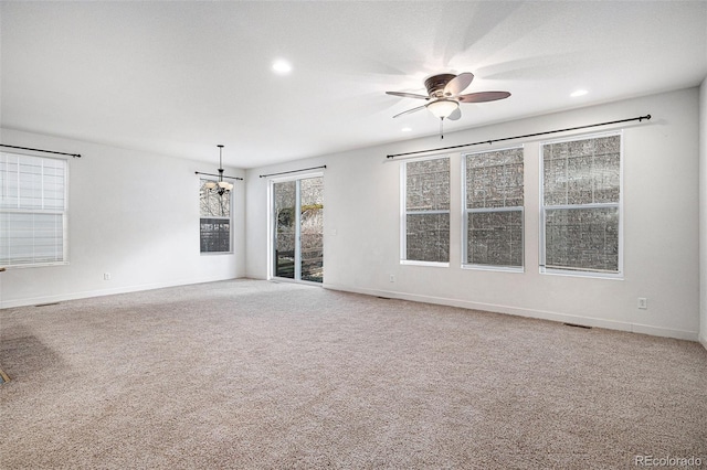 spare room featuring ceiling fan and carpet floors