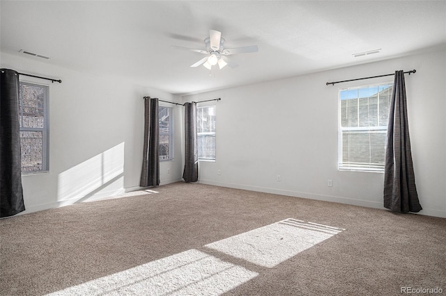 carpeted empty room featuring ceiling fan