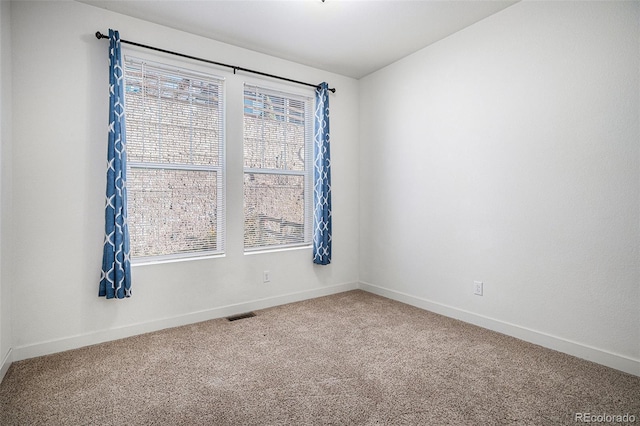 unfurnished room featuring carpet flooring and a healthy amount of sunlight