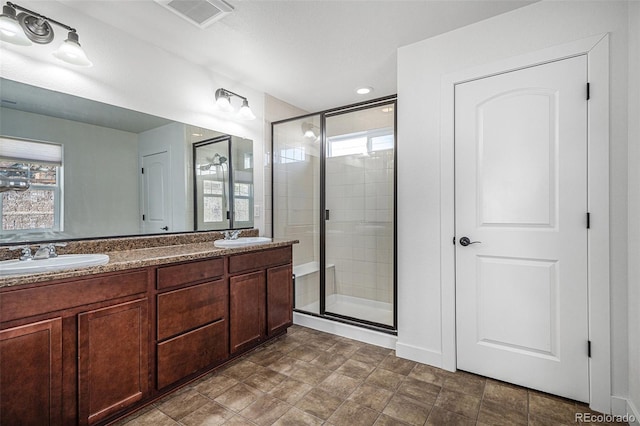 bathroom with plenty of natural light, vanity, and an enclosed shower