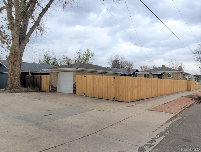 4901 Grove St, Denver, CO 80221 - view of property exterior featuring concrete driveway and brick siding
