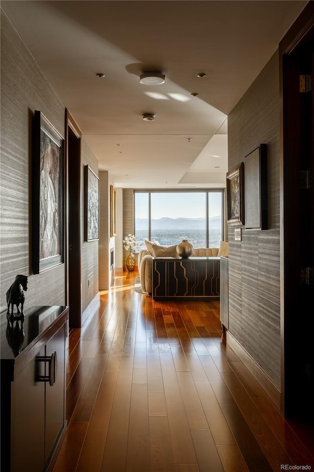 corridor with a water view and dark hardwood / wood-style floors