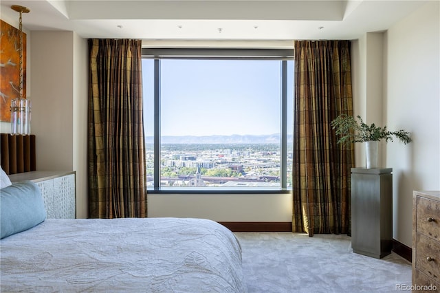 bedroom with light carpet and a mountain view