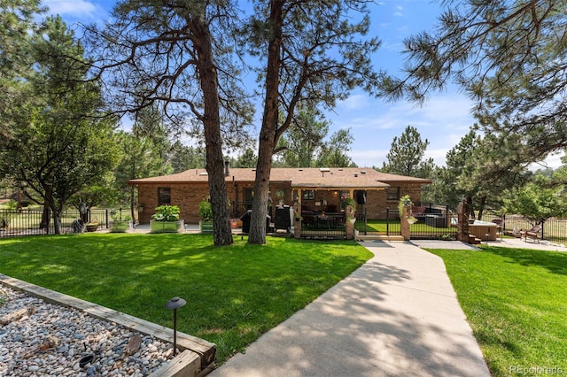 ranch-style house with a hot tub and a front yard