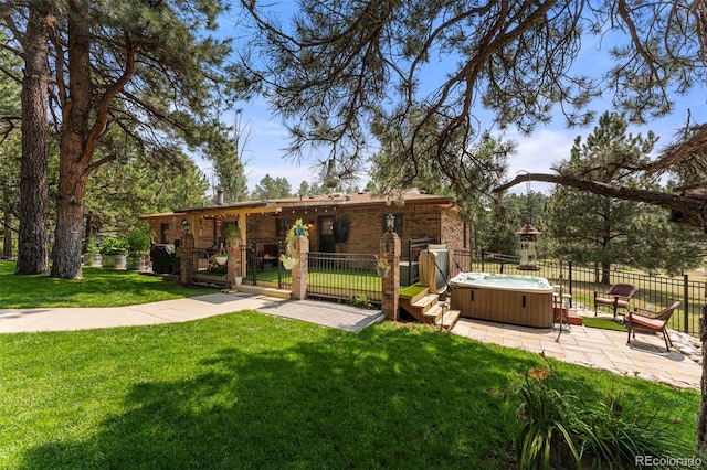 view of yard with a hot tub and a patio area