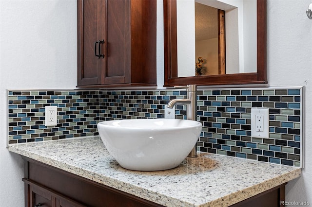 bathroom with tasteful backsplash and vanity