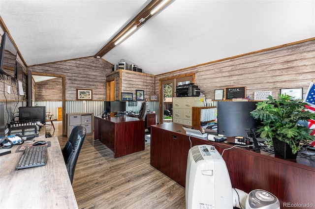 home office featuring wood-type flooring and vaulted ceiling with beams