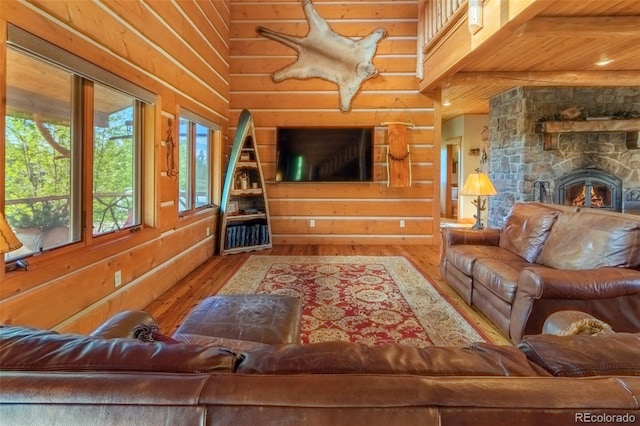 291 County Road 452, Grand Lake, CO 80447 - living area featuring hardwood / wood-style floors, wooden walls, a fireplace, and wooden ceiling with exposed beams