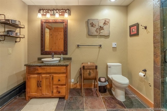 291 County Road 452, Grand Lake, CO 80447 - bathroom with baseboard heating, vanity, toilet, and baseboards