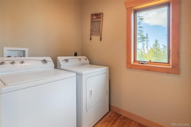 291 County Road 452, Grand Lake, CO 80447 - washroom with washing machine and dryer, light wood-style flooring, and baseboards