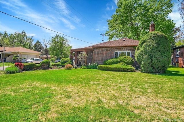 view of grassy yard featuring an attached garage