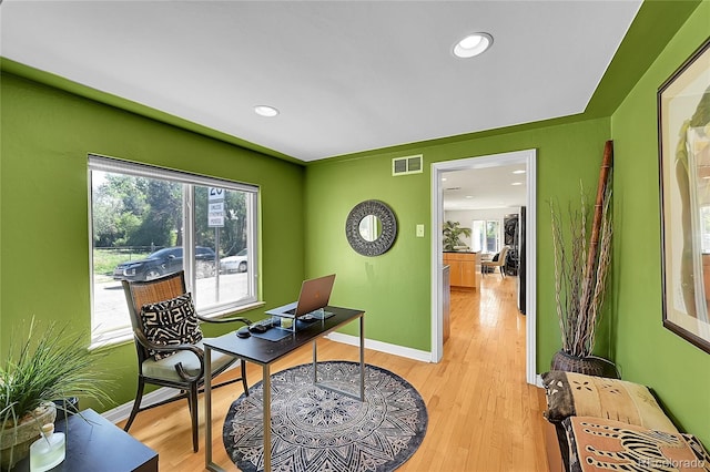 office space featuring baseboards, plenty of natural light, light wood finished floors, and recessed lighting