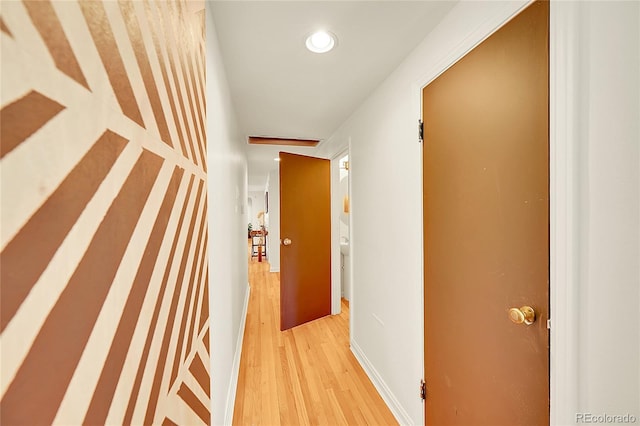hall with wood finished floors and recessed lighting