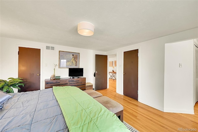 bedroom with light wood-style flooring and baseboards