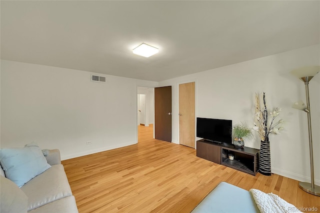 living room featuring light wood-style floors and baseboards