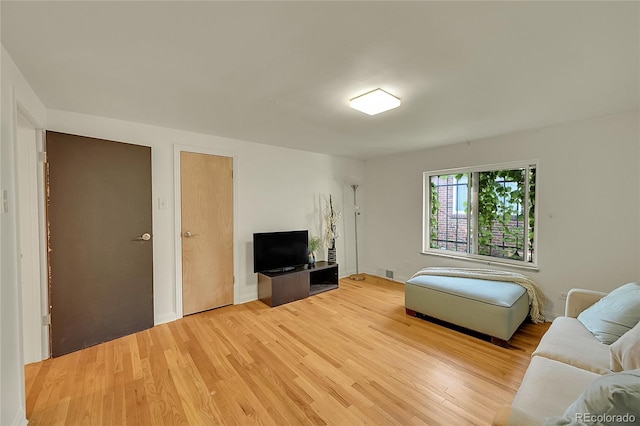 living room featuring light wood-type flooring and baseboards