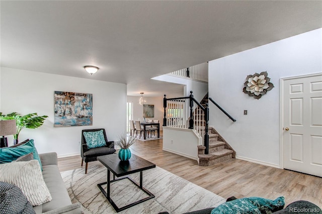 11183 E 114th Ave, Commerce City, CO 80640 - living area with light wood finished floors, stairway, a chandelier, and baseboards