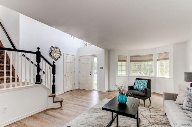 11183 E 114th Ave, Commerce City, CO 80640 - living area featuring stairs, wood finished floors, and baseboards