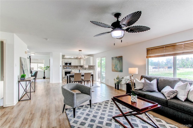 11183 E 114th Ave, Commerce City, CO 80640 - living area with plenty of natural light, light wood-style flooring, baseboards, and ceiling fan