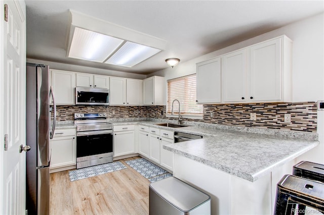 11183 E 114th Ave, Commerce City, CO 80640 - kitchen with stainless steel appliances, a sink, a peninsula, and white cabinets