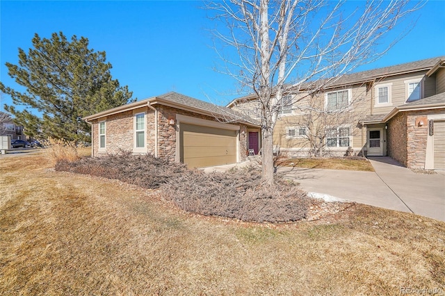 view of front of property with a garage and a front lawn