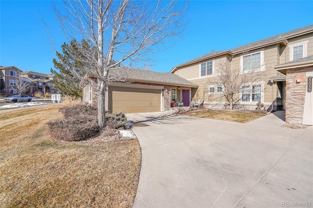 view of front of property featuring a garage and a front yard