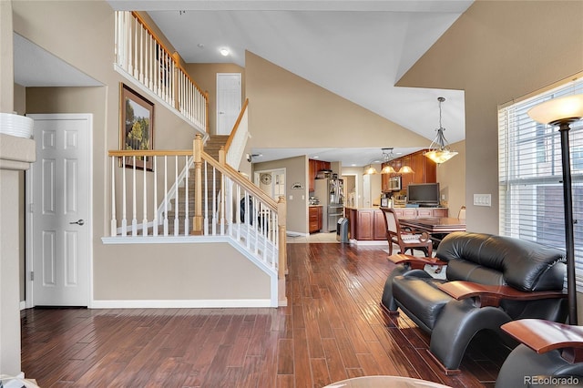 living room featuring dark hardwood / wood-style flooring and high vaulted ceiling