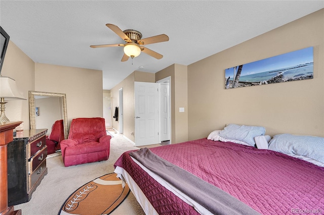 carpeted bedroom featuring ceiling fan and a textured ceiling