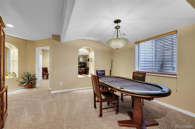 game room featuring vaulted ceiling and light colored carpet