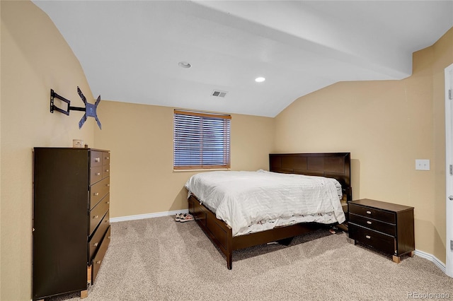 bedroom featuring lofted ceiling and light carpet