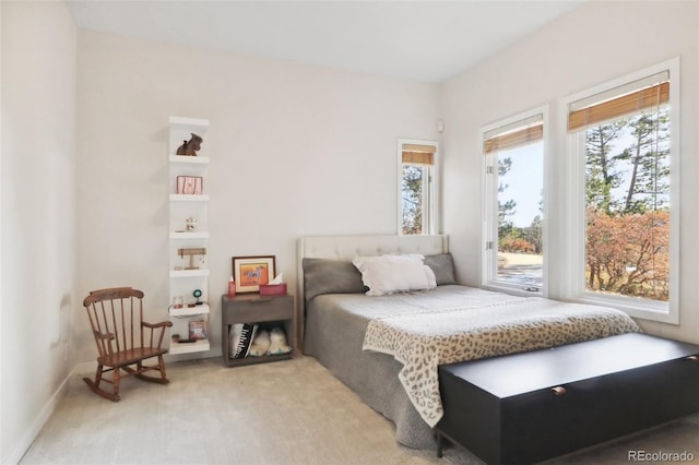 carpeted bedroom featuring multiple windows