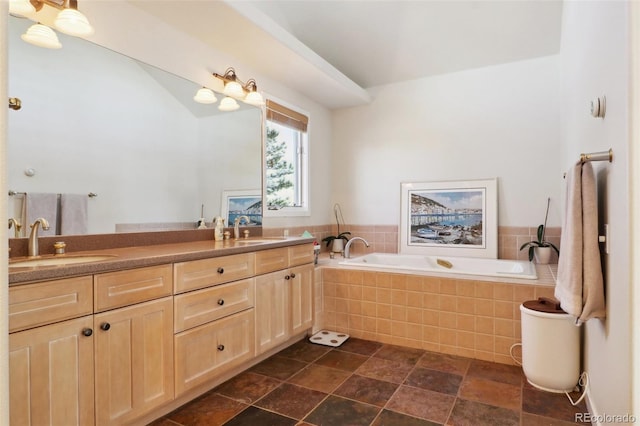 bathroom with vanity and tiled tub