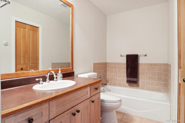 bathroom with tile patterned flooring, a washtub, toilet, and vanity