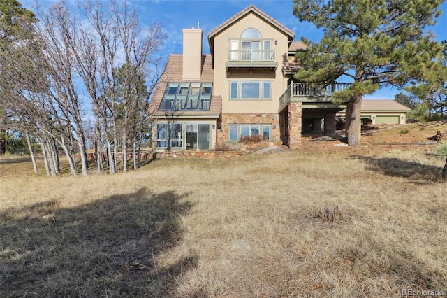 rear view of property with a balcony