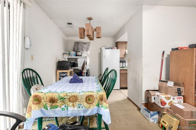2201 Sable Blvd Unit 1003, Aurora, CO 80011 - dining space with light colored carpet and a textured ceiling