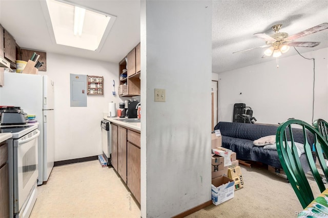 2201 Sable Blvd Unit 1003, Aurora, CO 80011 - kitchen with white electric range, electric panel, light countertops, a ceiling fan, and dishwashing machine