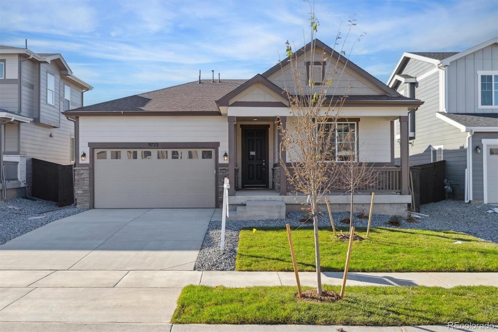 view of front of home with a garage and a front lawn