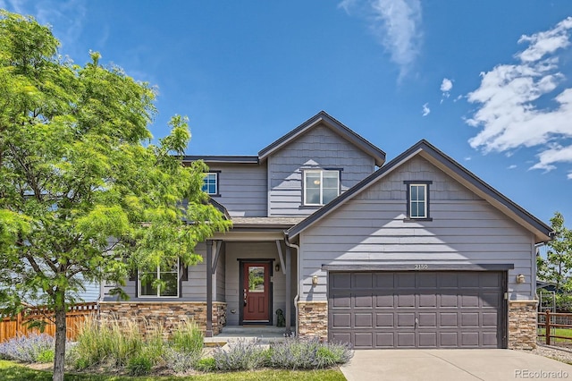 2150 Wagon Way, Louisville, CO 80027 - view of front of house with stone siding, driveway, and a garage