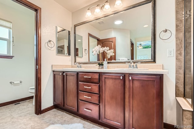 2150 Wagon Way, Louisville, CO 80027 - full bathroom with toilet, double vanity, baseboards, and tile patterned flooring