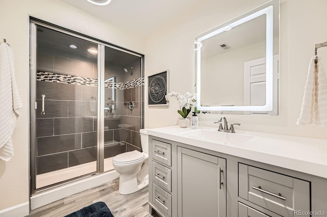 2150 Wagon Way, Louisville, CO 80027 - bathroom with vanity, a shower stall, toilet, and wood finished floors