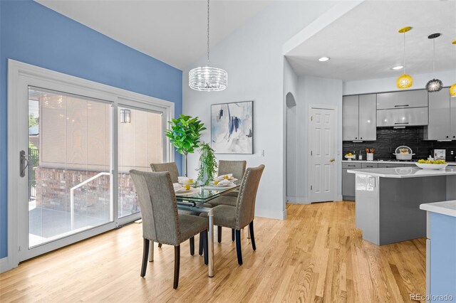 222 S Olive St, Denver, CO 80230 - dining room with light wood-style flooring, a chandelier, and arched walkways